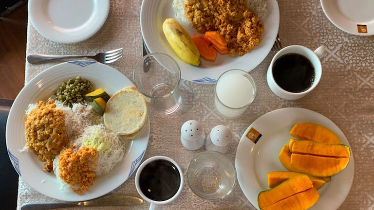 A traditional Sri Lankan breakfast consists of dhal curry, pol sambol, coconut roti and string hoppers.