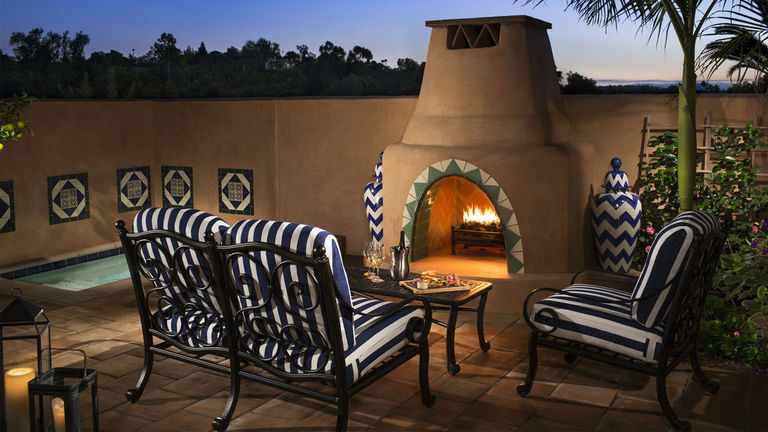 All rooms include an outdoor spa complete with a Spanish-style fireplace and seating area.