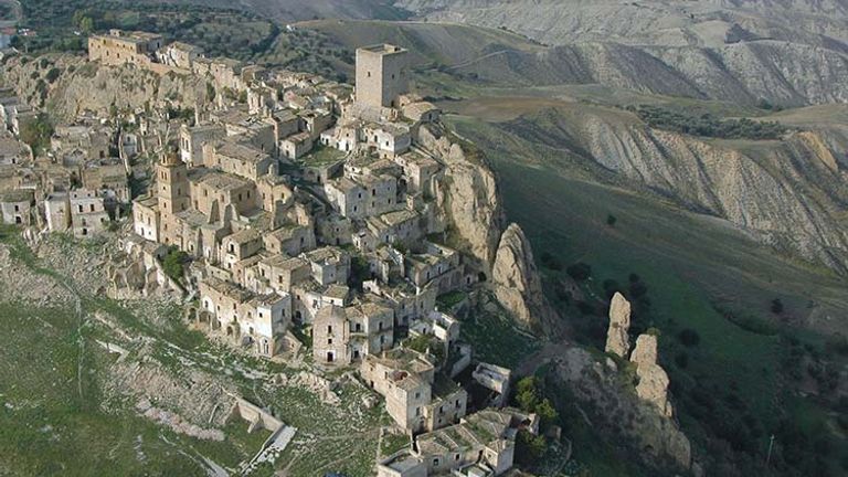 An aerial view of Craco, Italy, shows its unique surrounding landscape. // © 2017 Creative Commons user basilicatatravel