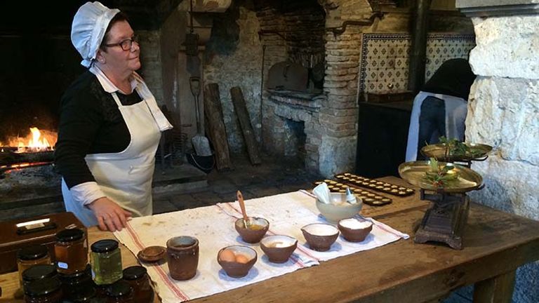 At the Chateau La Ferte Saint-Aubin, the cooks dress in traditional clothing as they demonstrate the art of baking French madeleine cookies. // © 2017 Giselle Abcarian