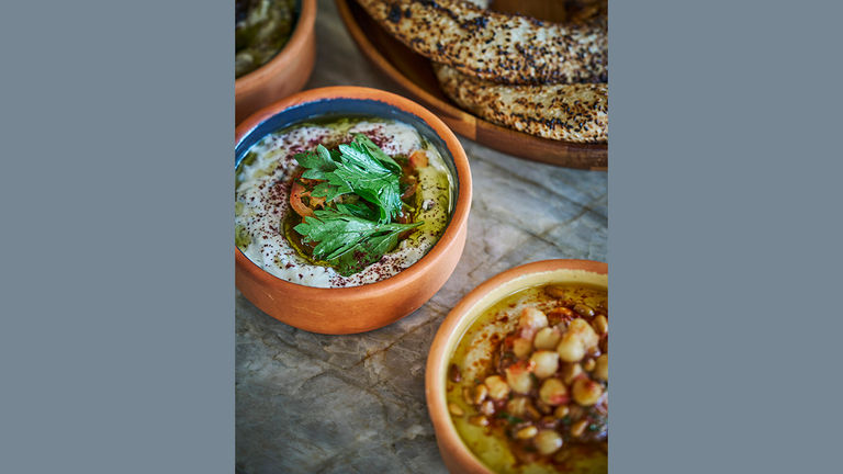 Chef Khaled Natour uses family recipes at the eatery; hummus is featured on the menu.