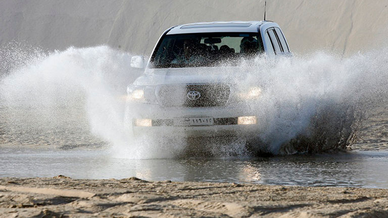 Dune bashing, or taking a thrilling ride in a four-wheel-drive vehicle all over desert sand dunes, is a popular excursion in Qatar. // © 2015 Gulf Adventures