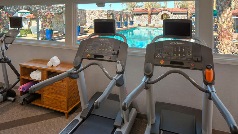 The on-site fitness center is located next to the pool and features basic equipment.