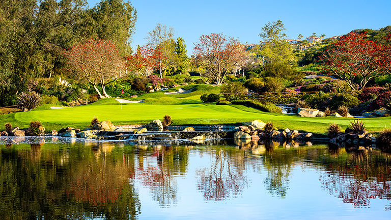 The on-site golf course is lushly landscaped with multiple water features.