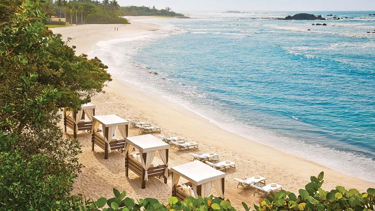 The property’s beach cabanas are ideal for relaxation.