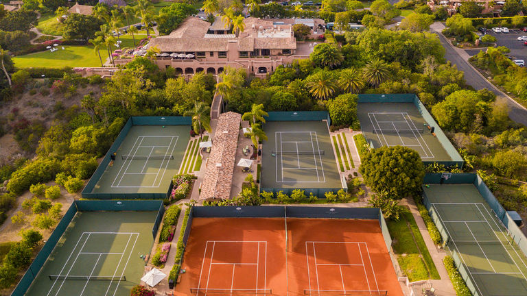 The property is known for its 18 tennis courts, including two red clay courts.