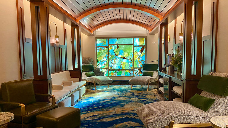 The yellow tones in the relaxation lounge stained-glass window depicts sun rays that represent fire.