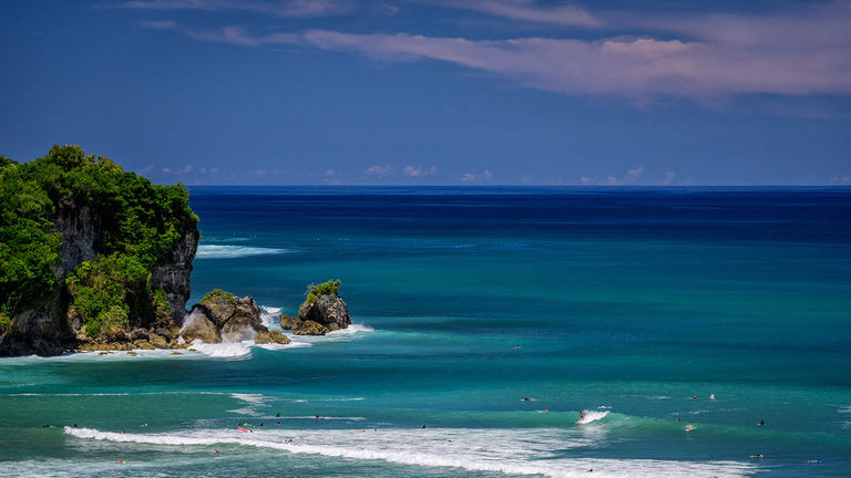 Watch surfers catch waves just outside Anantara Uluwatu Bali Resort.